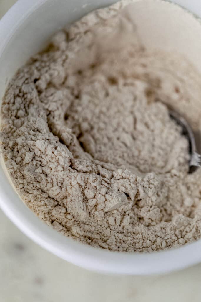 flour mixture in white bowl for peach cobbler muffins