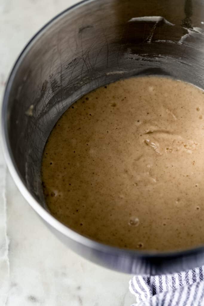 mixture for peach cobbler muffins in silver mixing bowl