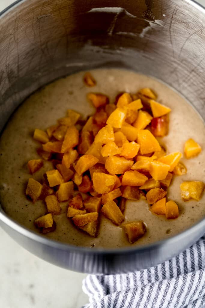peaches added to mixing bowl with muffin mixture