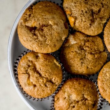 close up view peach cobbler muffins in a large serving bowl