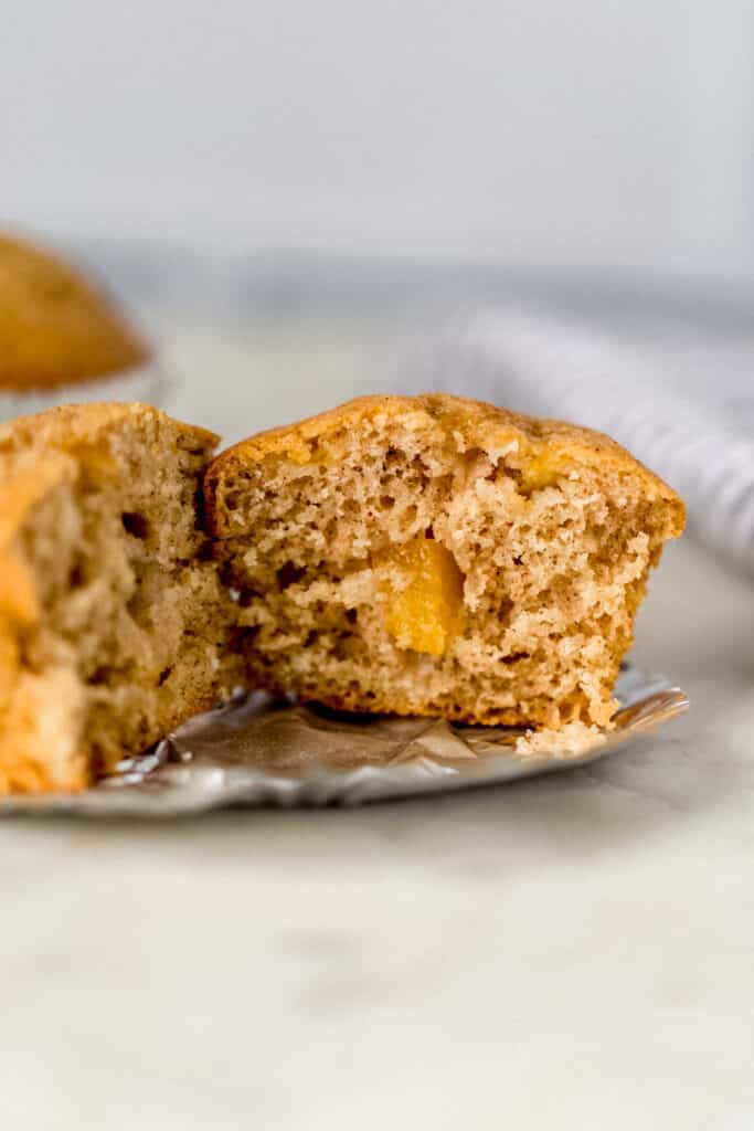 single baked peach cobbler muffin cut in half