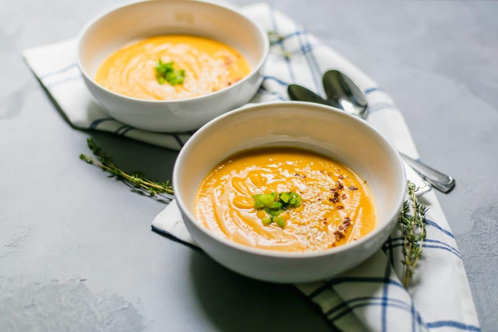 Close-up view Sweet Potato Miso Soup in two bowls with spoons