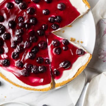 no bake blueberry cheese cake next to slice on separate white plate