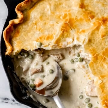overhead view of finished pot pie with pieces missing and spoon in it