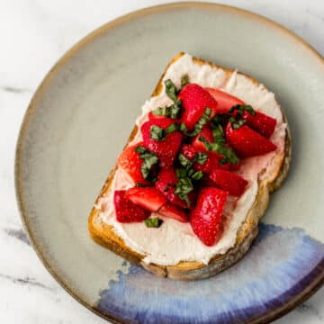 overhead view of toast on a plate topped with basil