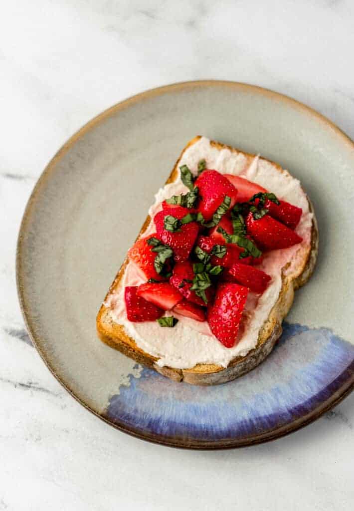 overhead view of toast on a plate topped with basil