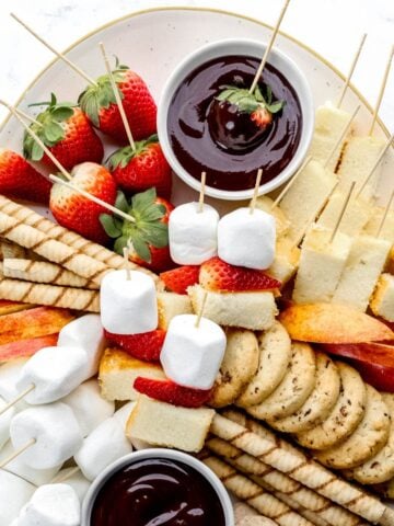 Close up overhead view of chocolate fondue dippers on dessert board.