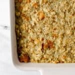 Finished cornbread dressing in white rectangle baking dish.