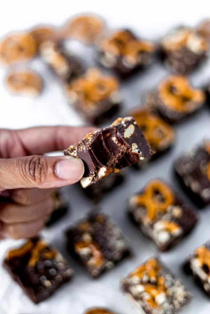 hand holding pretzel fudge with bite in it