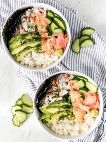 California Roll Bowl in two bowls with a napkin and cucumber