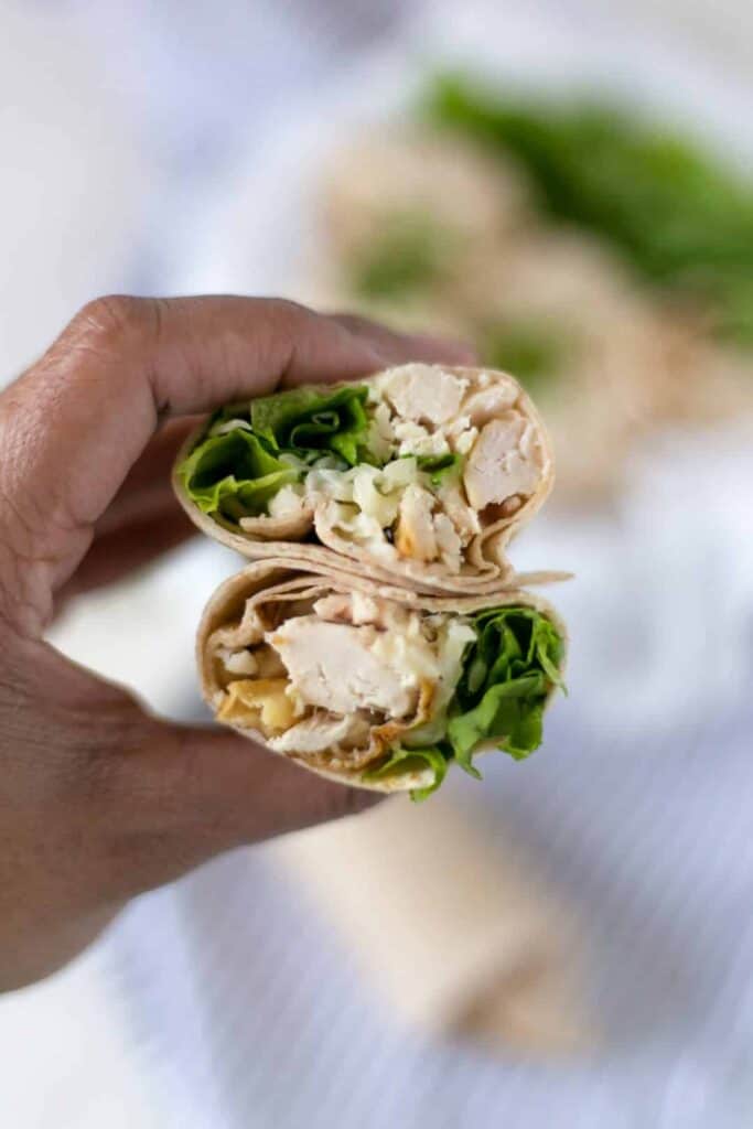 hand holding chicken ranch wrap cup in half