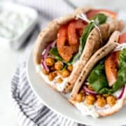 Close up view of finished gyros on white plate.