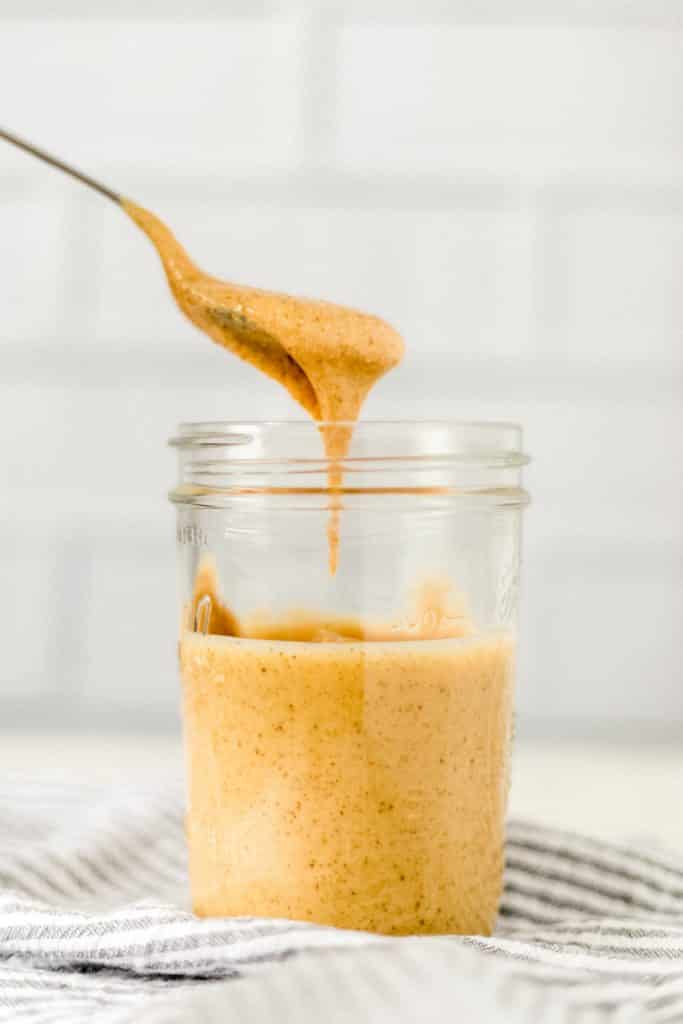 side view homemade peanut butter with spoon