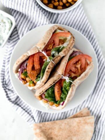 overhead view of gyros on white plate on top of cloth napkin