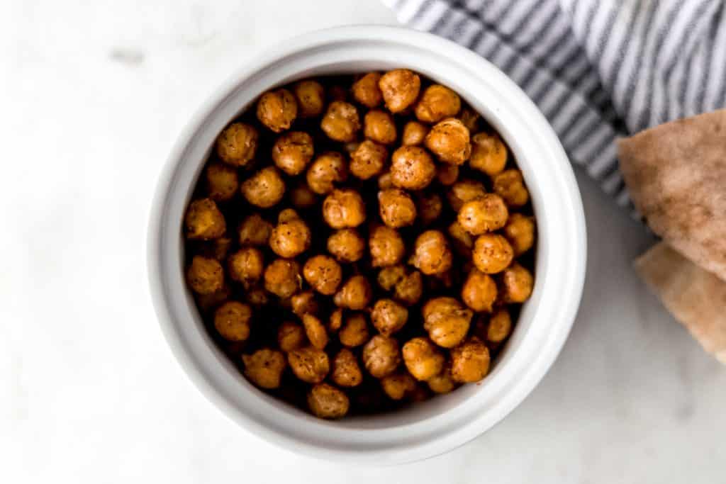 spicy roasted chickpeas in a round white bowl 