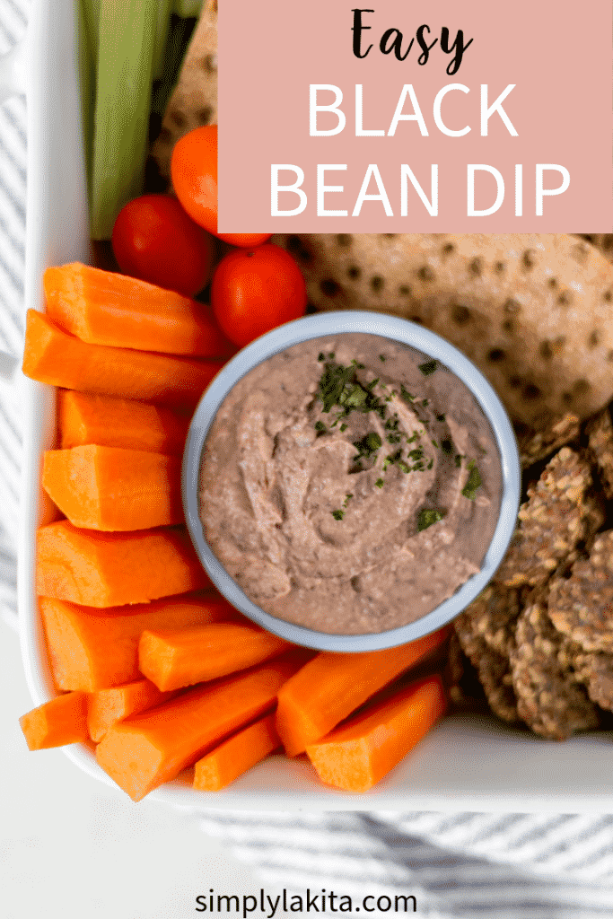 overhead view of black bean dip in a bowl with carrots