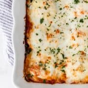 Overhead view of finished lasagna in baking dish.