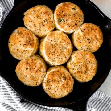 overhead view of cheddar biscuits in a cast iron skillet