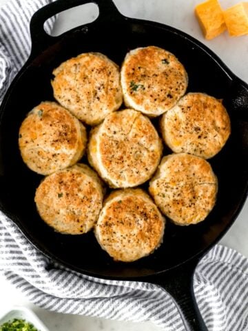 overhead view of cheddar biscuits in a cast iron skillet