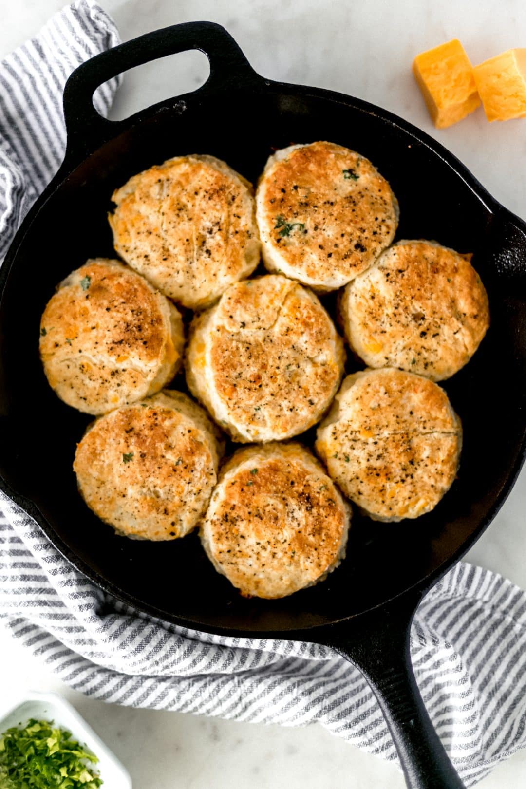overhead view of cheddar biscuits in a cast iron skillet