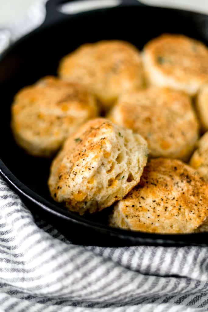 close-up side view of cheddar biscuits in cast iron skillet
