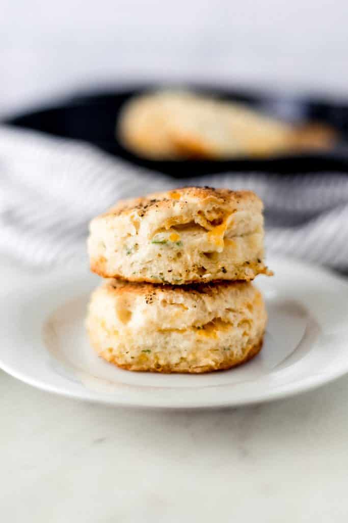 close-up side view of two cheddar biscuits stacked on a plate