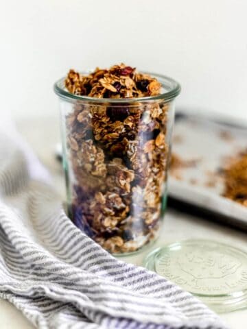 close-up side view of homemade granola in a jar with napkin