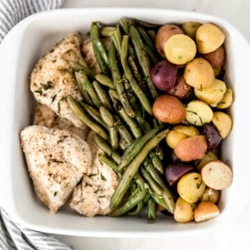 white platter with chicken, potatoes, and green beans