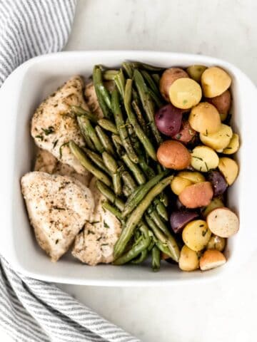 white platter with chicken, potatoes, and green beans