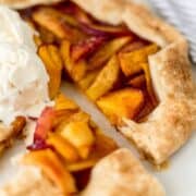 Close up view of galette sliced and topped with ice cream.