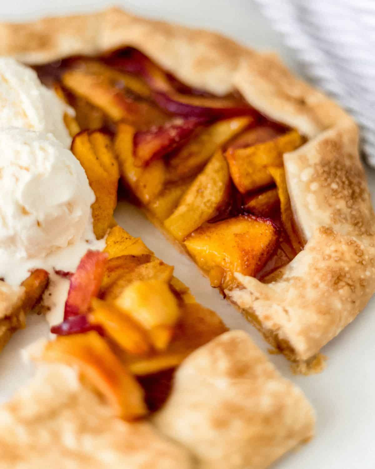 Close up view of finished galette topped with scoops of ice cream.