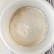 Overhead view of self-rising flour in white bowl.