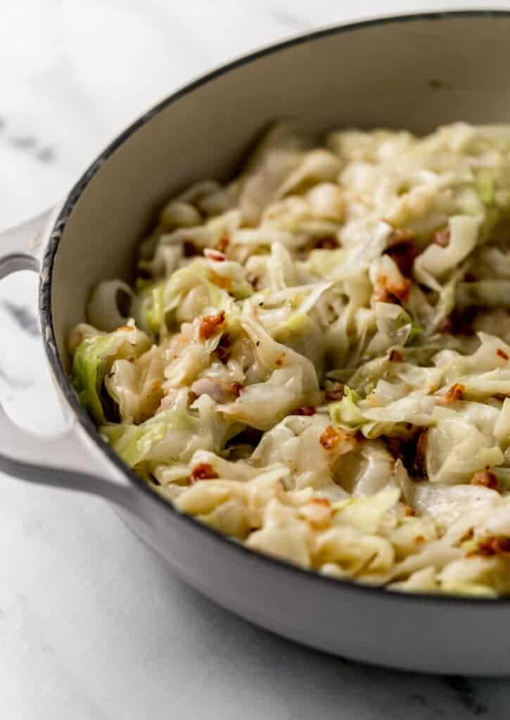 finished cabbage combined with bacon and sauce in large skillet