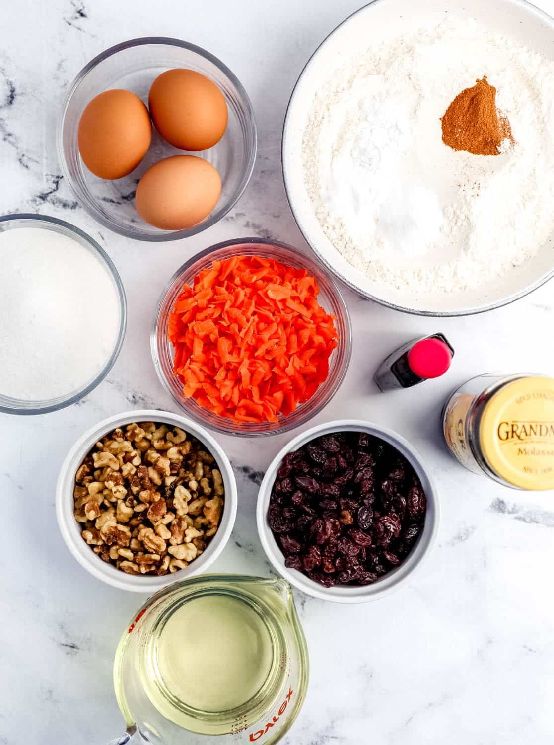 Overhead view of ingredients needed to make bread in separate bowls.