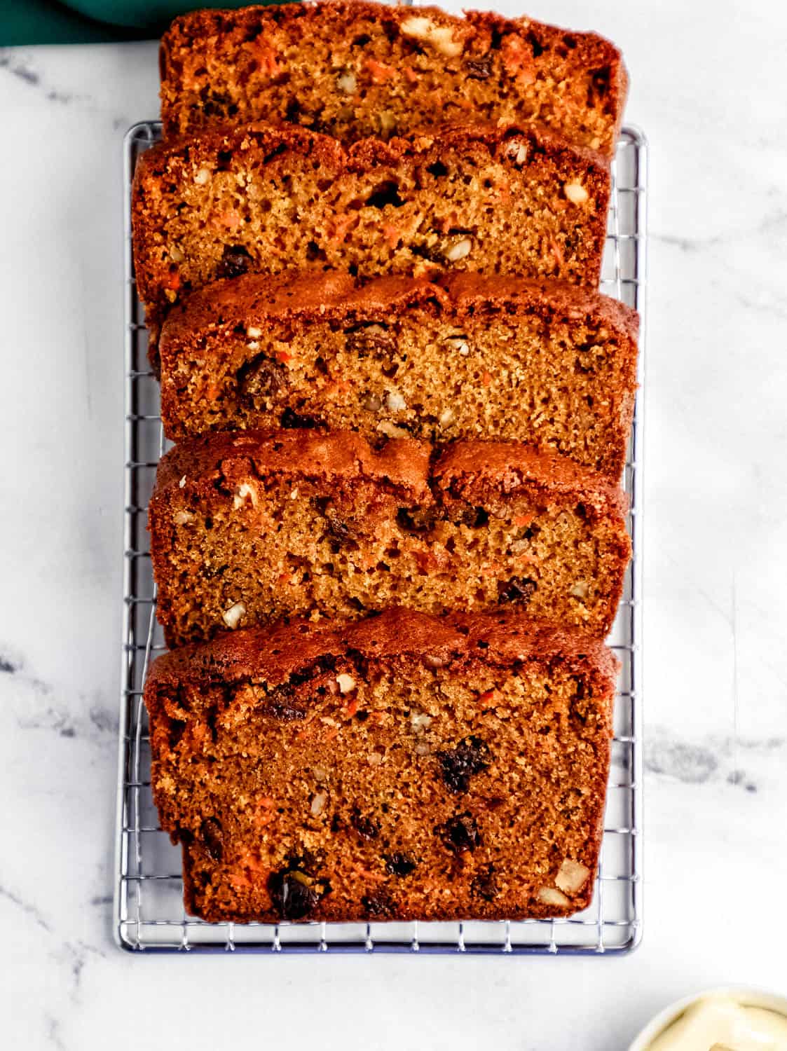 Overhead view of sliced bread on metal grate.