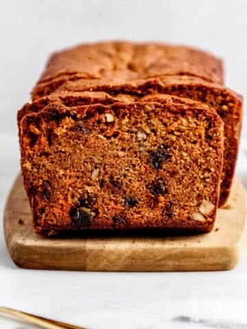 Close up front view of sliced bread on wooden board.