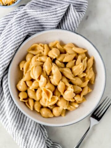 pressure cooker mac and cheese in bowl with napkin and fork