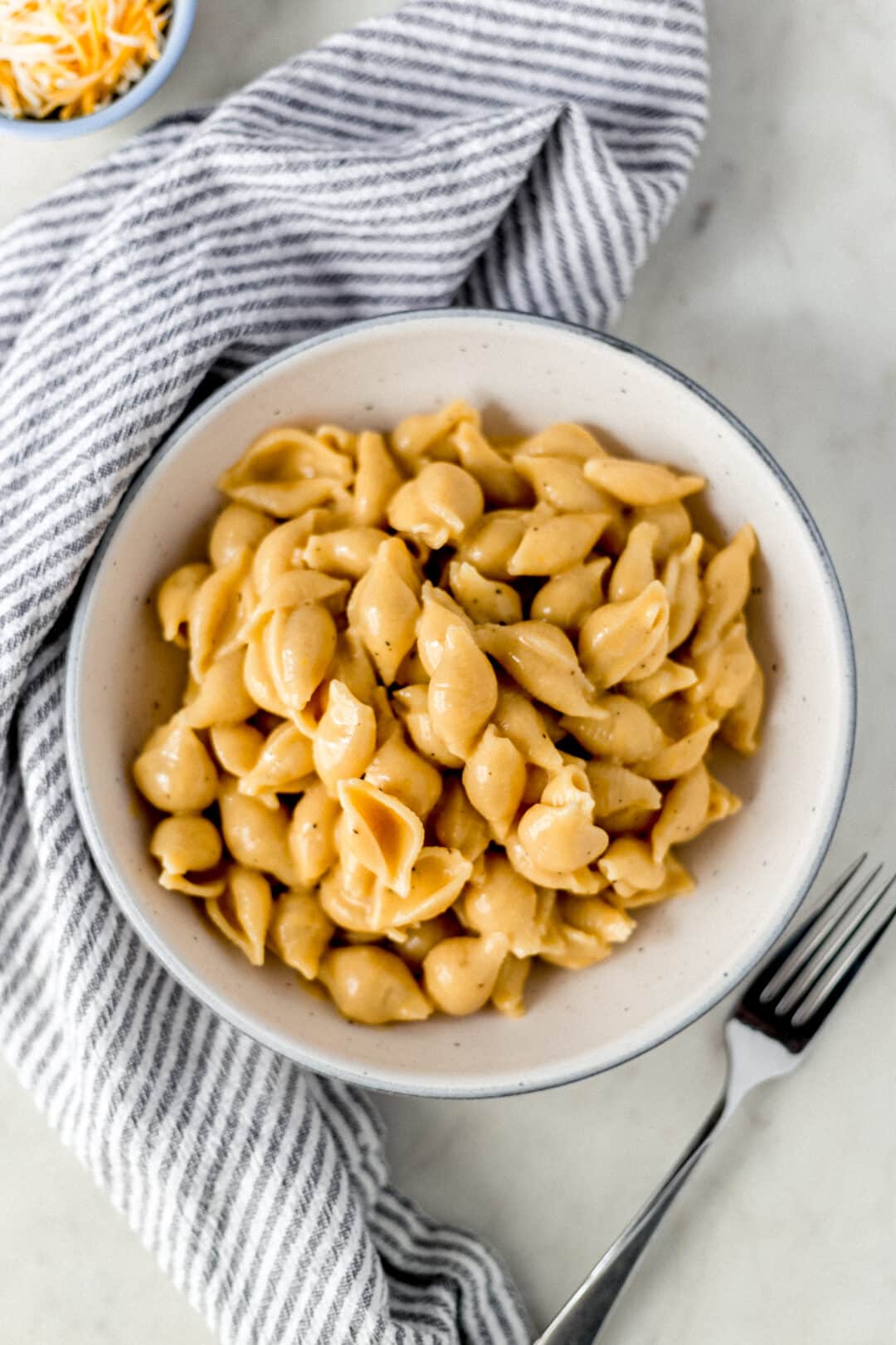 pressure cooker mac and cheese in bowl with napkin and fork