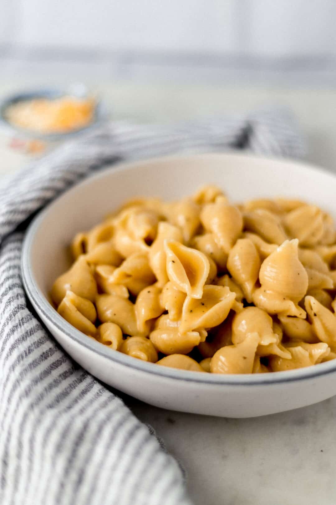 close-up side view instant pot mac and cheese in bowl next to a napkin