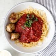 Overhead view of bowl of pasta with meatballs.