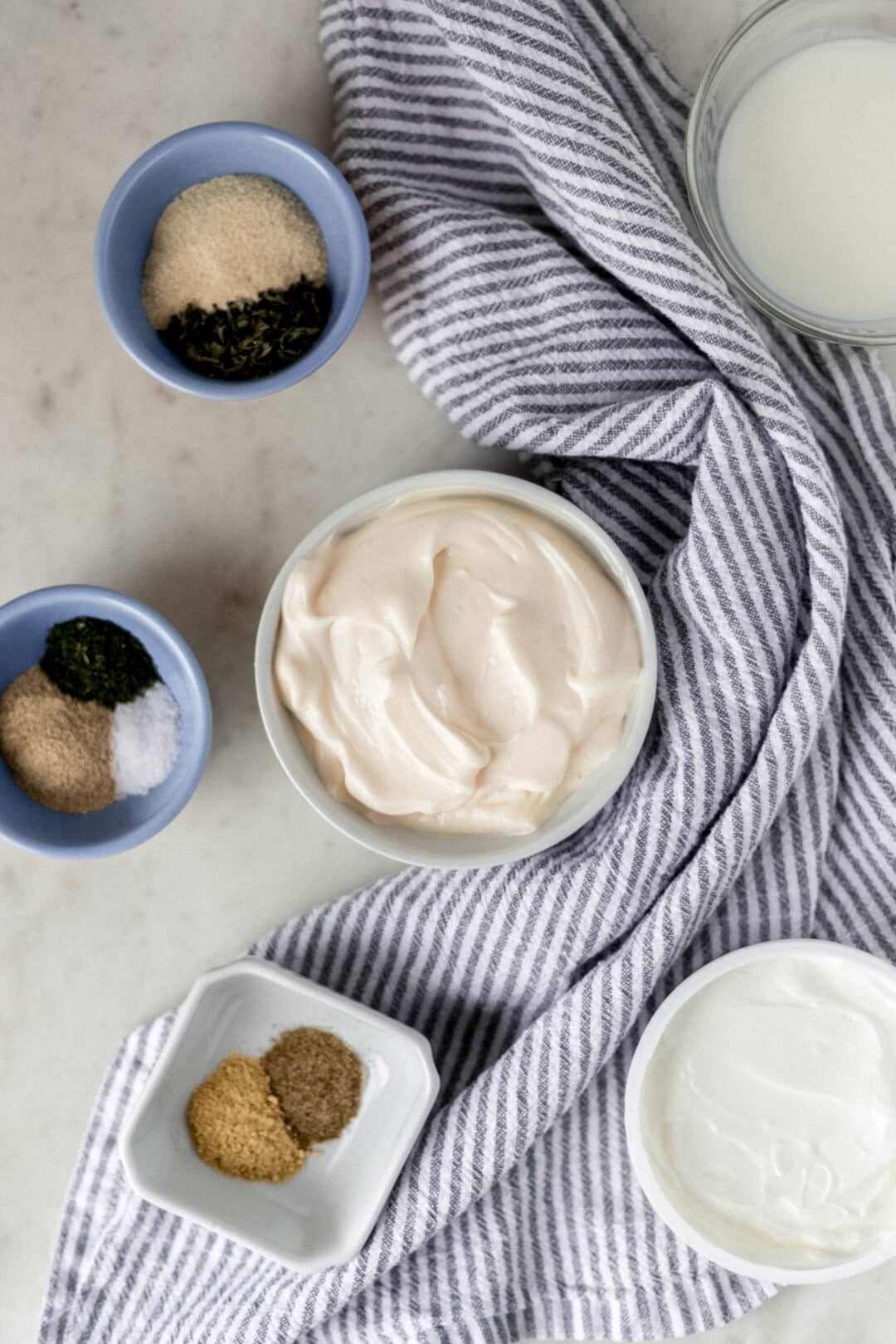 ingredients for homemade ranch dressing in small bowls with napkin