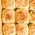 Close up view of biscuits in parchment lined baking dish.