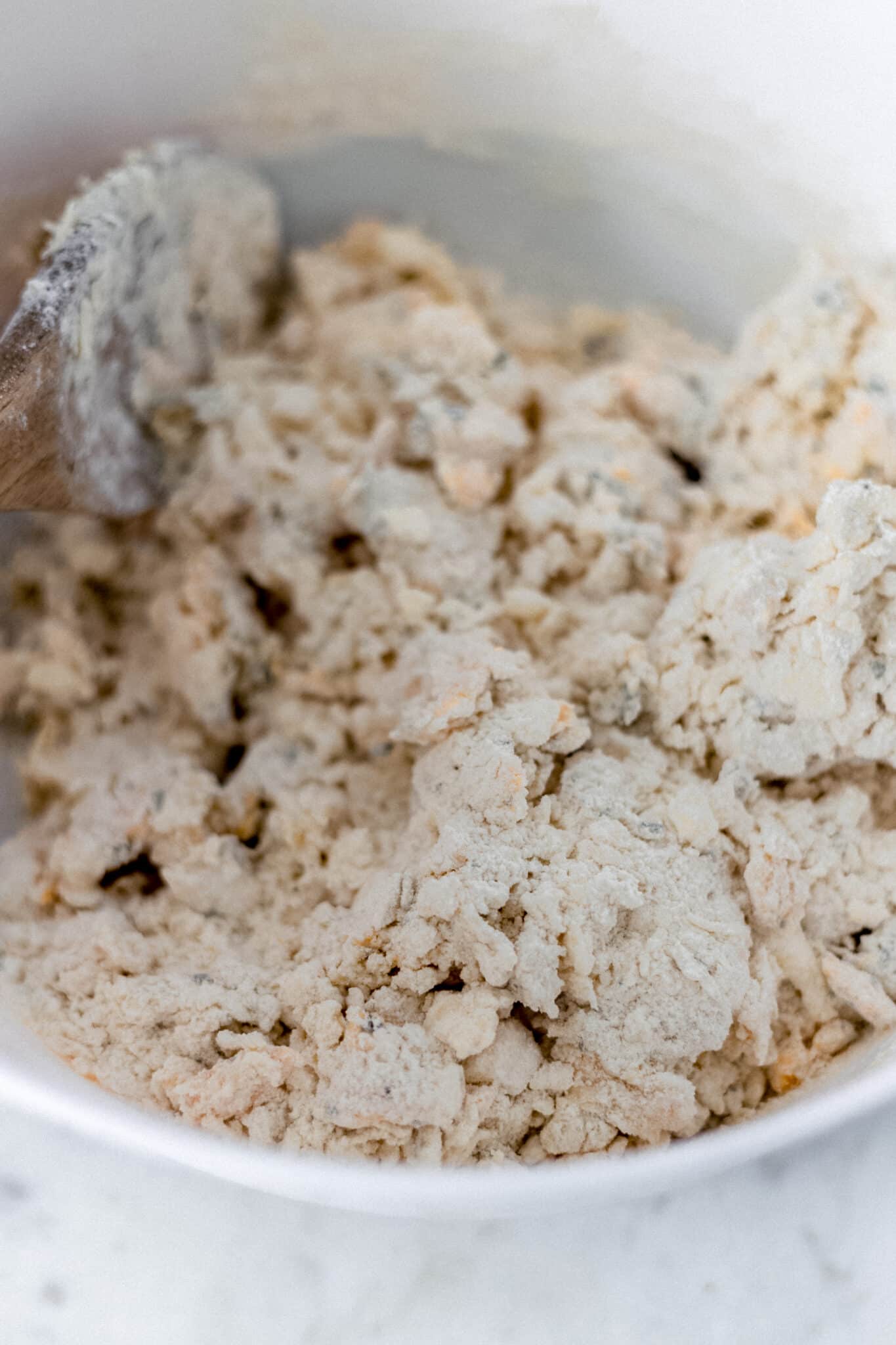 homemade cheddar herb biscuit dough in mixing bowl