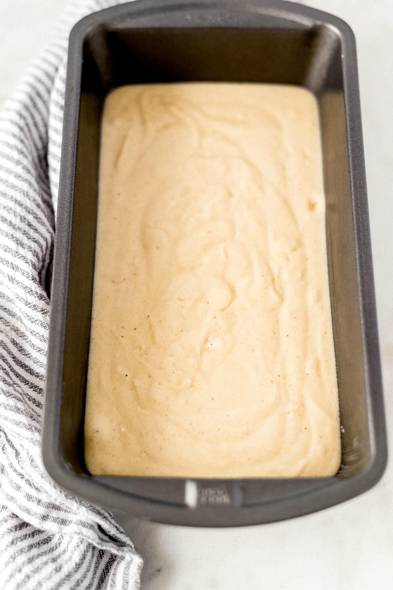 eggnog pound cake batter in a loaf pan before cooking in the oven