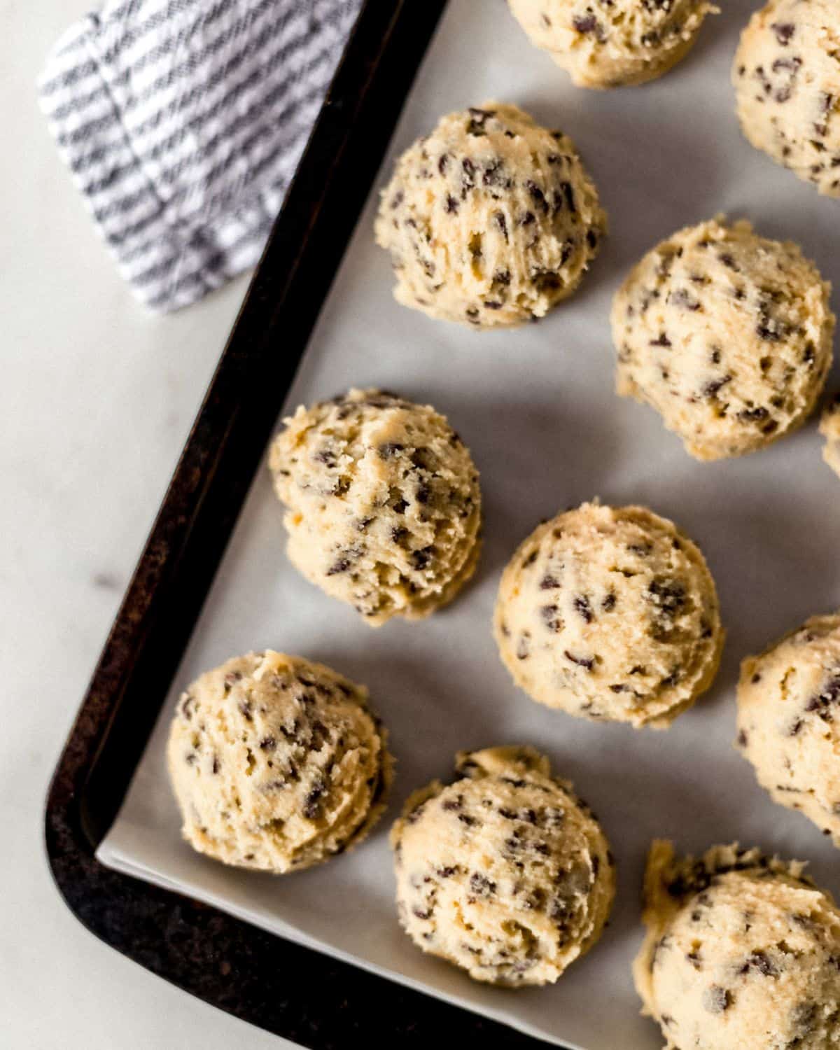 Cookie dough on parchment lined sheet pan.
