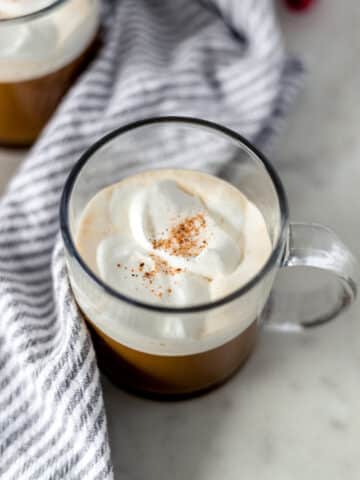 gingerbread latte in a mug topped with whipped topping and a sprinkle of nutmeg