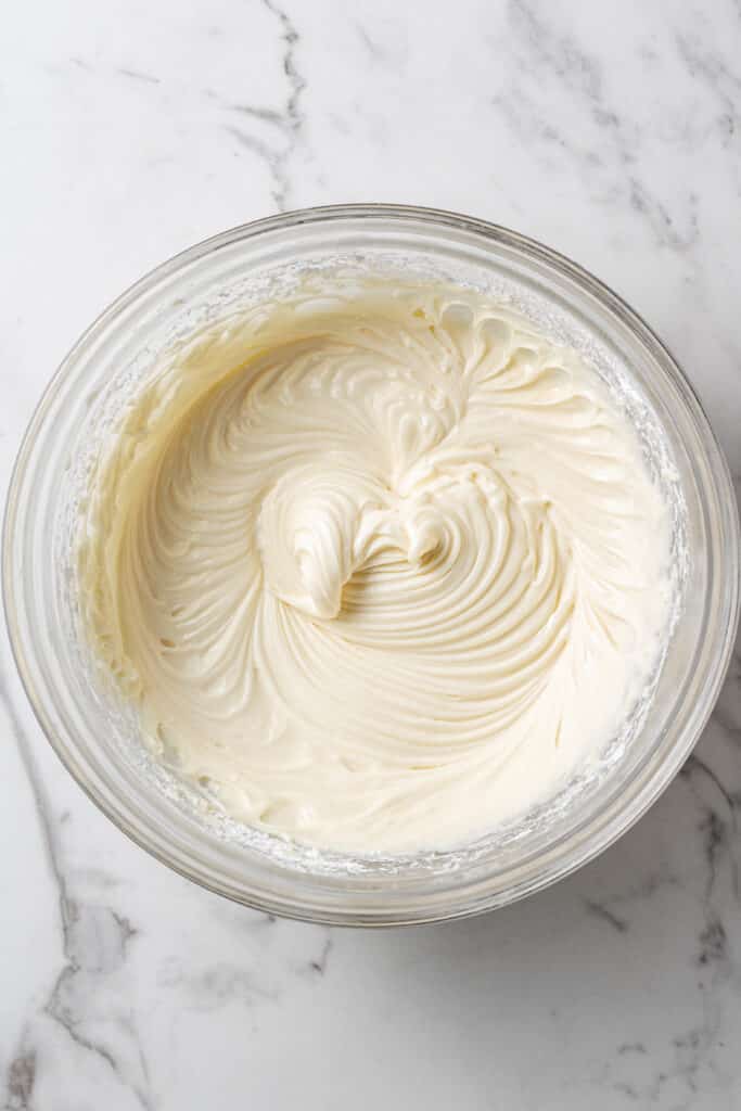 pie filling ingredients combined together in glass mixing bowl 