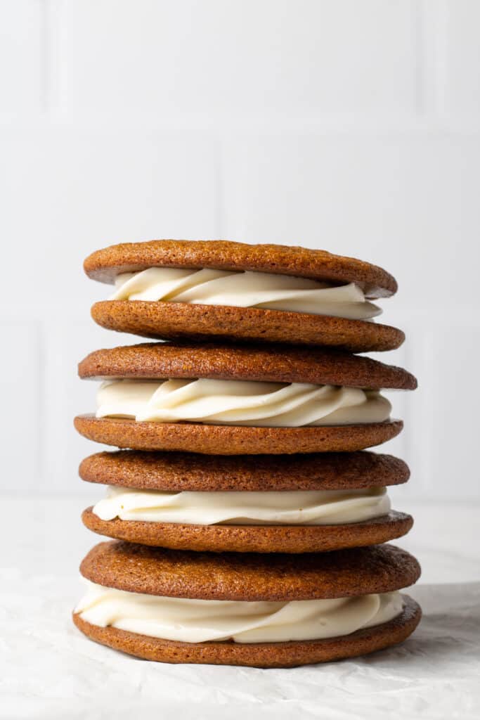 close up side view gingerbread pies stacked on top of each other.