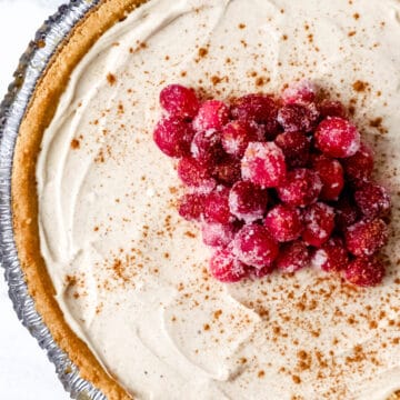 Overhead view of finished cheesecake topped with cranberries.