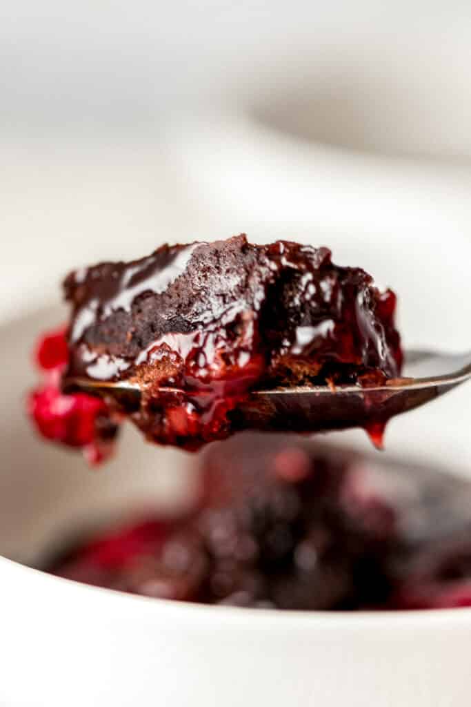 instant pot chocolate cherry dump cake on spoon being held by hand